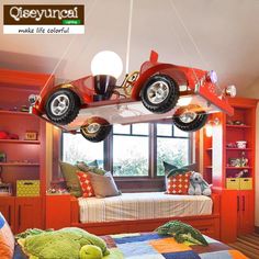 a bed room with a large red car suspended from the ceiling