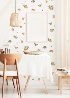 a dining room with white walls and oranges on it's wall decals