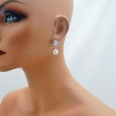 These gorgeous earrings feature a sparkling rhinestone teardrop accented with a large 10mm Swarovski pearl to complete the look. Pearl is available in 5 colors (white, ivory, light pink, light grey and dark grey). Comes in a gift box, perfect for gift giving. These measure approximately 1 inch long in total length. Shown on a life sized mannequin for reference. ALSO AVAILABLE AS CLIP ON EARRINGS: www.etsy.com/listing/713708747/clip-on-bridal-earrings-clipon-weddingSHIPPING: This item ships by US Elegant Teardrop Rhinestone Earrings, Elegant Teardrop Earrings With Rhinestones, Elegant Teardrop Earrings With Rhinestones For Gifts, Teardrop Crystal Pearl Earrings For Formal Occasions, Teardrop Crystal Pearl Earrings For Formal Events, Elegant Teardrop Earrings With Rhinestones As Gift, Teardrop Crystal Pearl Drop Earrings, Formal Crystal Teardrop Earrings With Pearl Drop, Formal Crystal Pearl Drop Teardrop Earrings