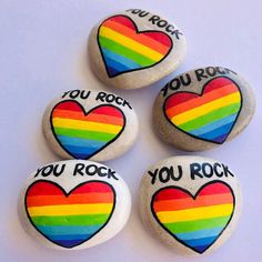 four rainbow rocks with you rock written on them and a heart painted on the stones