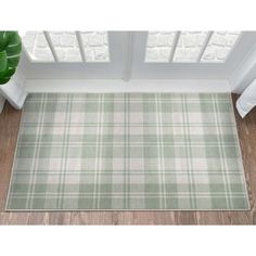 a green and white checkered rug on the floor