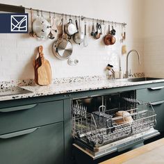 the dishwasher is full of dishes and utensils hanging on the wall