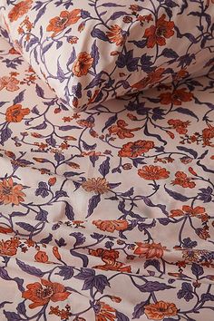 an orange and purple floral print sheet set