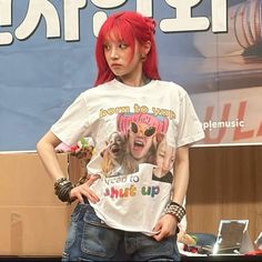 a woman with red hair wearing a t - shirt that says, boom to yeah