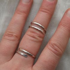 This adjustable hammered sterling silver ring is designed for both men and women who enjoy wearing minimalist style jewelry. This ring is super lightweight and comfortable, making it the perfect everyday wear with any outfit. Stack it or mix and match with other metals. Puffy fingers are no match for this ring! Completely handcrafted by me (Kahlia) in Washington State out of my school bus work studio. Handmade with raw 925 sterling silver wire, this ring is hammered to perfection and polished to Everyday Adjustable Hammered Stackable Rings, Minimalist Adjustable Hammered Midi Rings, Everyday Hammered Open Ring, Modern Hammered Adjustable Rings, Minimalist Hammered Ring With Open Band, Minimalist Hammered Open Band Ring, Minimalist Hand Forged Open Midi Rings, Everyday Minimalist Hammered Midi Rings, Adjustable Dainty Hammered Midi Rings