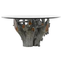 a glass table with wood and metal decoration on the top, in front of a white background