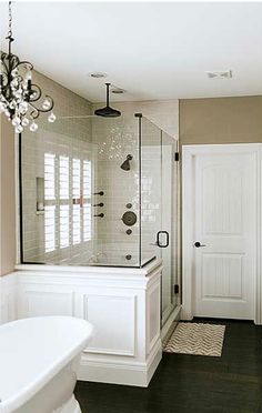 a large bathroom with a tub, shower and sink in the middle of it's walls