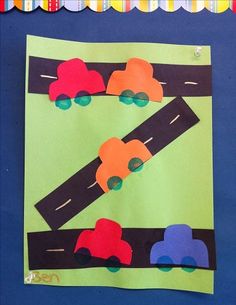 this is an art project for kids to do with construction paper and construction vehicles on the road