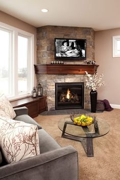 a living room with a fire place and a flat screen tv mounted above the fireplace