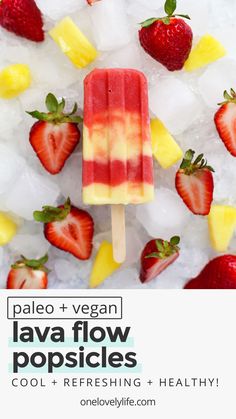 a popsicle with fruit on top and ice cubes around it, surrounded by strawberries