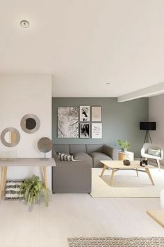 a living room filled with furniture next to a wall mounted art piece on the wall