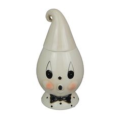 a white ceramic figurine with a black bow tie on it's head