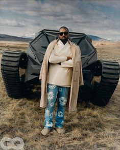 a man standing in front of an armored vehicle