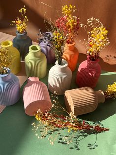 many different colored vases with flowers in them