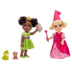 two dolls are standing next to each other with toys in front of them on a white background