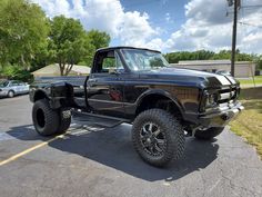 a large black truck parked in a parking lot