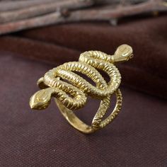 Gold Snake Ring, Brass Ring, Serpent Ring, Gothic Ring, Snake Jewelry, Snake Statement Jewelry, Goth, Punk SIZE :- All Size Are Available, choose from variation. METAL :- Brass ❥ Customers satisfaction is our biggest priority, please contact us with any questions/queries for future or existing orders, and we will do our best to make sure you are happy with your order. ♥ Please Make Sure to Include The Correct Address During Before Order. You Can return Item within 30 Days After Successful Delivery. We Offer 100% Money Back Guarantee If You Not Satisfied With Your Purchase. Return Charge Will Be Paid By Buyer Only. This is my shop link https://www.etsy.com/in-en/shop/AustereGifts?ref=seller-platform-mcnav Thank you🥰 for shopping with us! Black Obsidian Ring, Jewelry Goth, Full Finger Rings, Obsidian Ring, Serpent Ring, Snake Lovers, Gothic Ring, Long Ring, Metaphysical Healing