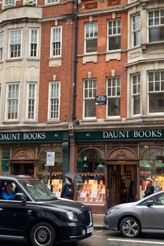 two cars parked in front of a book store