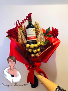 a bottle of wine and some chocolates in a bouquet