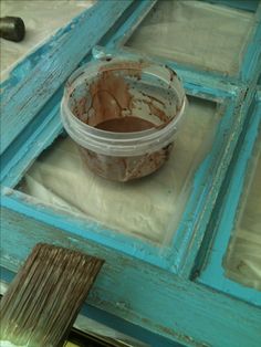 a bucket of paint sitting on top of a table