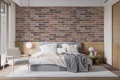 a bedroom with a brick wall and bed in the corner, next to a chair