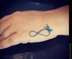 a person's hand with a tattoo on it and the word love is in the middle