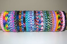 a roll of multicolored bracelets sitting on top of a white table next to a wall