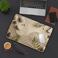 a computer mouse pad sitting on top of a desk next to a cup of coffee