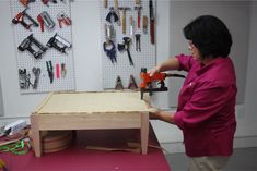 a woman working with tools on a table