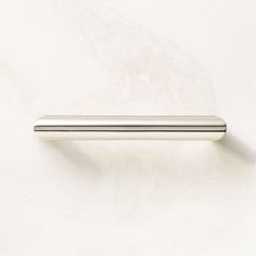 a metal handle on a white wall