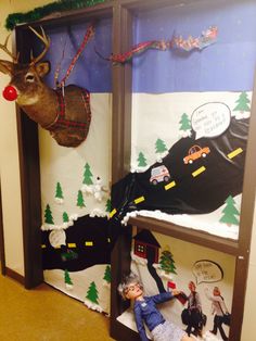 an office cubicle decorated for christmas with toys and decorations on the wall, including a deer head