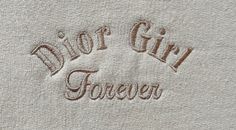 the embroidered name of a shirt that says, not girl forever on it's chest