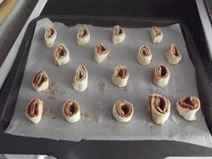 there are many small pastries on the baking sheet ready to be baked in the oven