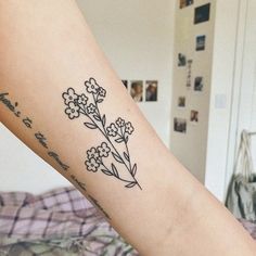 a woman's arm with a flower tattoo on the left side of her body