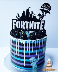 a blue and black striped cake with the word fortnite on it's top