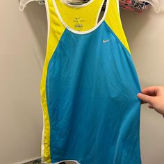 Nike Yellow And Blue Racer Back Tee Shirt. Nike Yellow, Tops Nike, Loose Tank Tops, Running Tank Tops, Nike Tank, Nike Tank Tops, Gray Tank, Nike Tees, Nike Blue