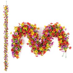 the letter m made out of flowers is next to a long string of beads and thread