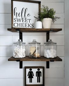 two shelves with jars and other items on them in the bathroom, one has a sign that says hello sweet cheeks