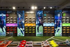 soccer shoes are on display in front of an advertisement for the new nike football shoe collection