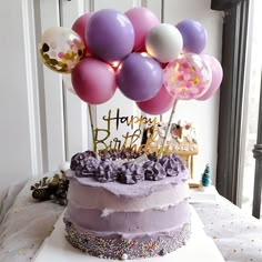 a birthday cake with lots of balloons on top