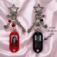 two key chains with pictures attached to them on a pink satin background, one has a star and the other has a photo