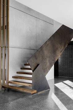 a metal stair case sitting next to a wall