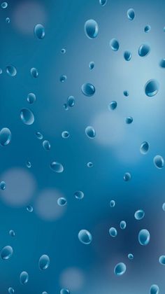 drops of water on a window pane with blue sky and clouds in the background