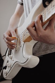 a man is playing an electric guitar