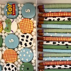 two trays filled with different types of cookies and candies next to each other