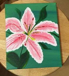 a painting of a pink flower on a green background