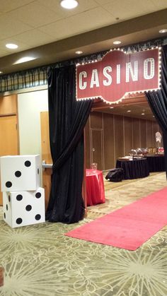 a casino themed event with dices on the floor and black drapes over them