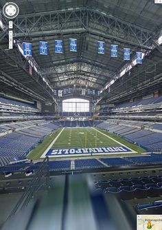 an empty football stadium filled with blue seats