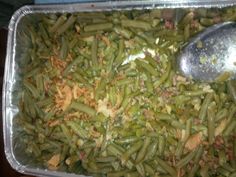 green beans are being cooked in a pan with a spoon