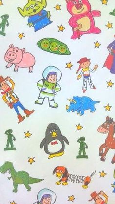 children's drawings on a white sheet with stars and cartoon characters all over them